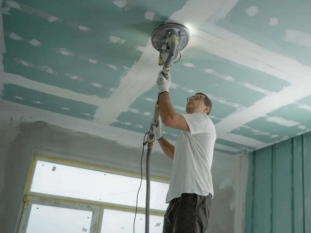 man polishing the ceiling