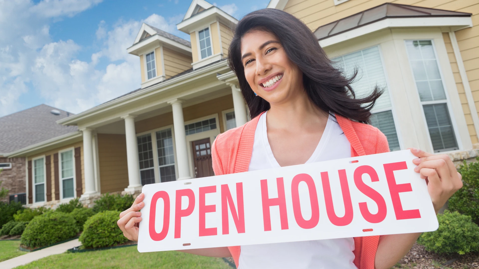 Woman holding open house sign