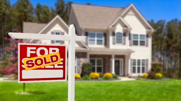 sold sign in front of house