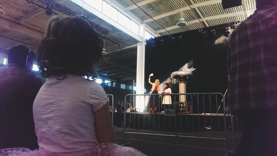 Girl in crowd watching the carnival performance