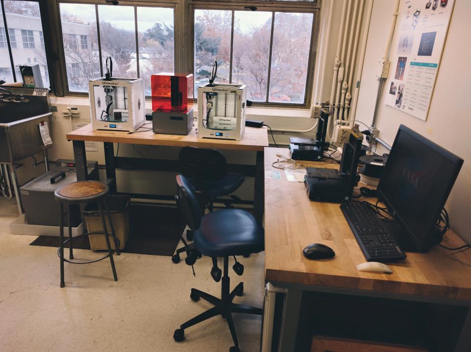 An office space with 3d printers and a computer