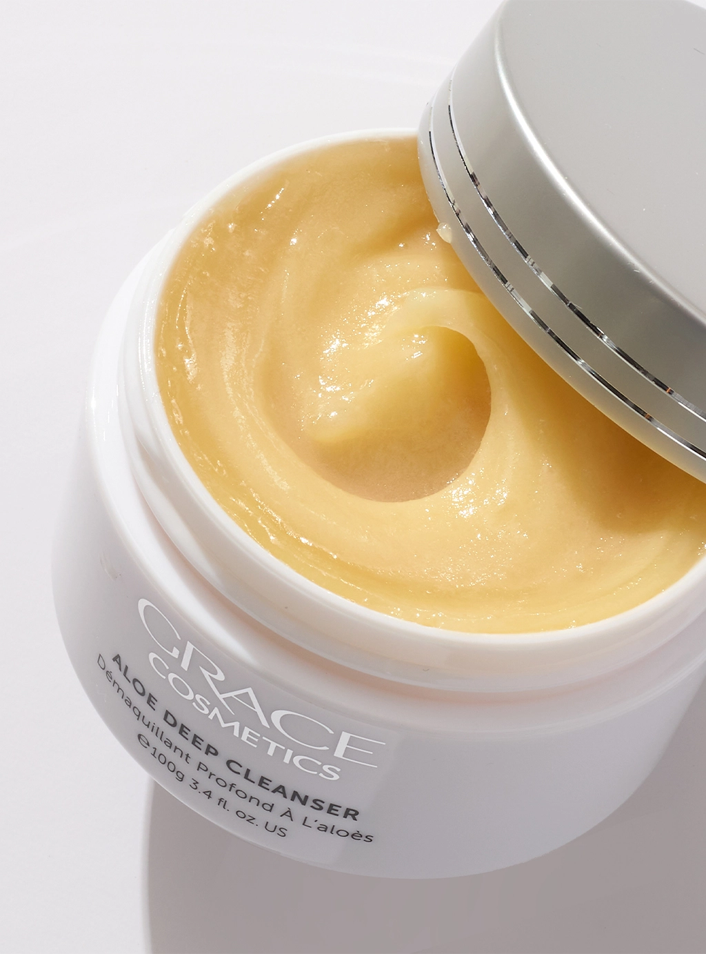 Close up of open Aloe Deep Cleanser Jar with product texture swirled