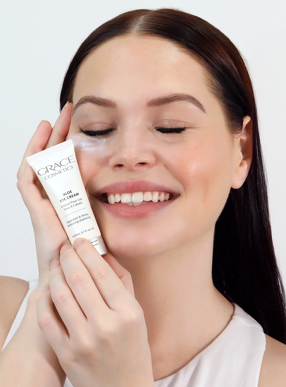 Person holding Aloe Eye Cream applying product under eyes