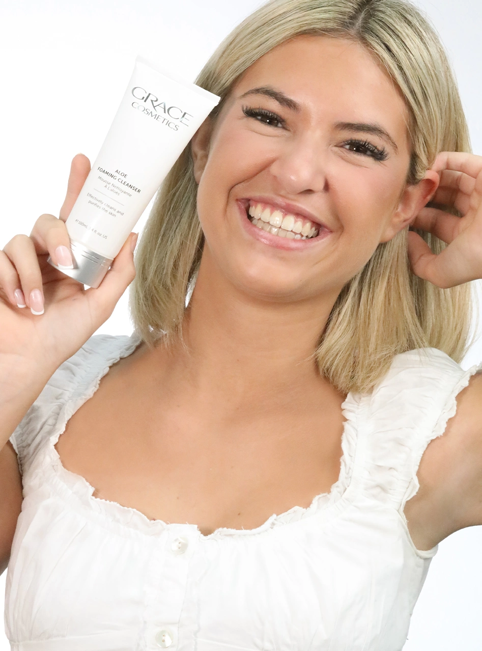 Blonde model holding foaming cleanser