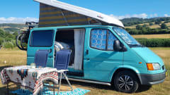 Retro turquoise camper, ready for a road trip. 
