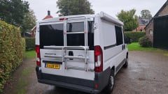 Peugeot boxer with fixed bed and large lifting roof