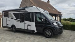 Luxury 4-person motorhome with bicycle rack and tow bar, model 2026