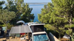 cool and cozy off grid camper van with lifting roof.