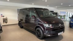 Biscy – 4 berth VW Campervan (Gas stove, 2 double beds, & gated car storage)