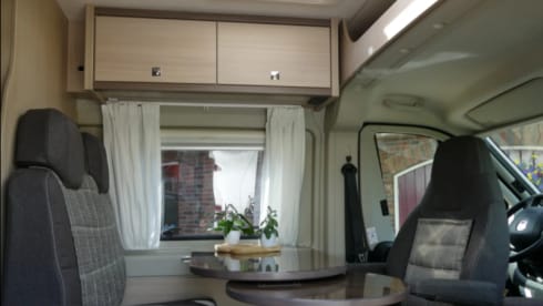 Bus camper with awning, private shower and toilet.