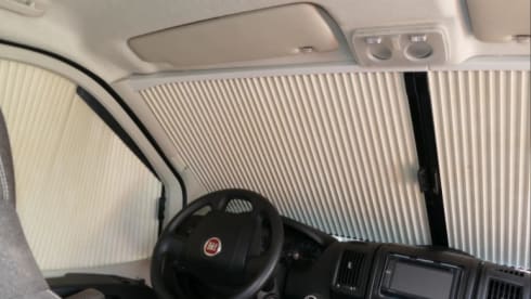 Bus camper with awning, private shower and toilet.