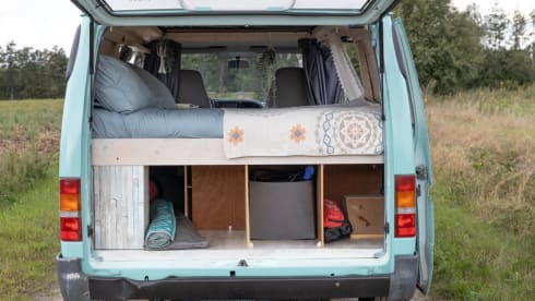 Retro turquoise camper, ready for a road trip. 