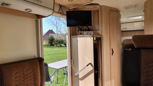 luxury camper including queen-size bed, pull-down bed and large garage and tow bar