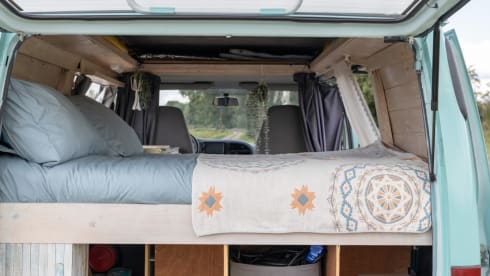 Retro turquoise camper, ready for a road trip. 