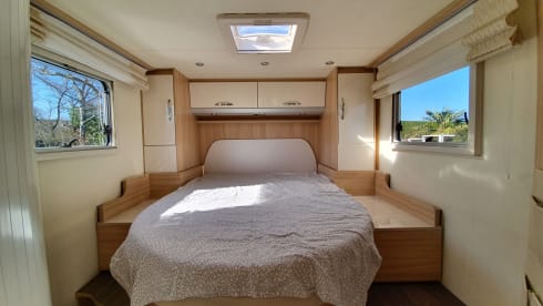 luxury camper including queen-size bed, pull-down bed and large garage and tow bar