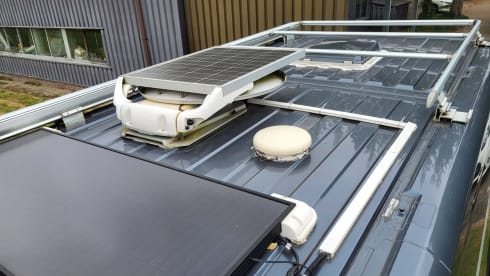 Neat camper van with length beds and solar panels