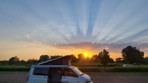 cool and cozy off grid camper van with lifting roof.