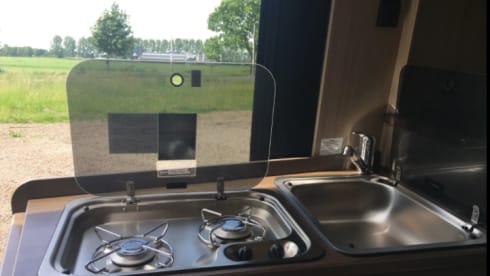 Bus camper with awning, private shower and toilet.