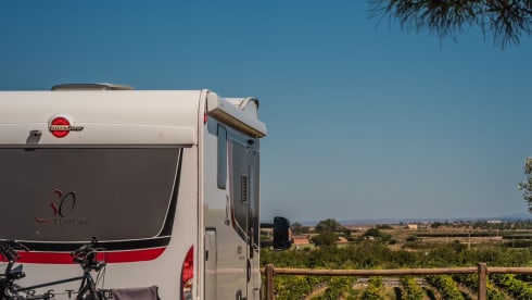 luxury camper including queen-size bed, pull-down bed and large garage and tow bar