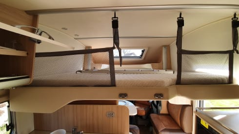luxury camper including queen-size bed, pull-down bed and large garage and tow bar