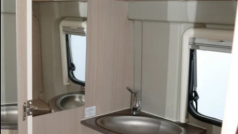 Bus camper with awning, private shower and toilet.