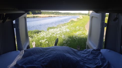 Bus camper with awning, private shower and toilet.