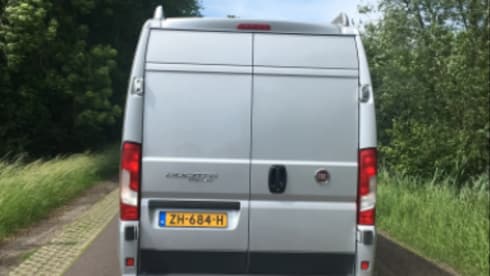 Bus camper with awning, private shower and toilet.