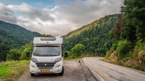 luxury camper including queen-size bed, pull-down bed and large garage and tow bar
