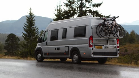 Bus camper with awning, private shower and toilet.