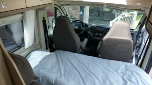 Bus camper with awning, private shower and toilet.