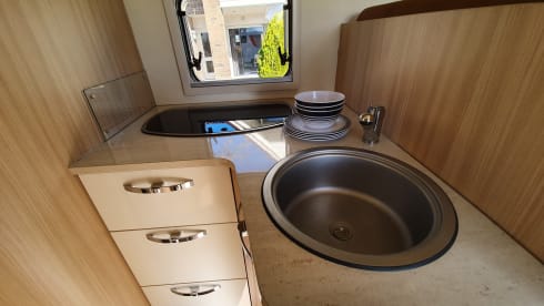 luxury camper including queen-size bed, pull-down bed and large garage and tow bar