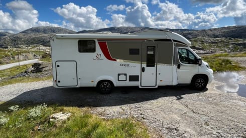 luxury camper including queen-size bed, pull-down bed and large garage and tow bar