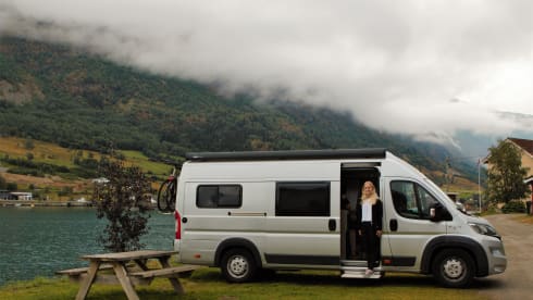 Bus camper with awning, private shower and toilet.