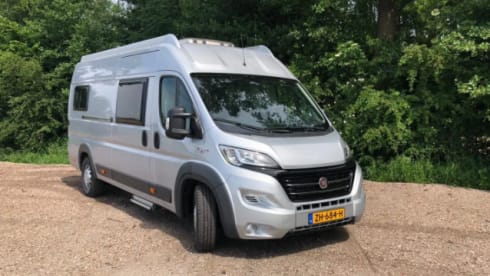 Bus camper with awning, private shower and toilet.