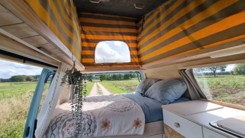 Retro turquoise camper, ready for a road trip. 