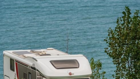 luxury camper including queen-size bed, pull-down bed and large garage and tow bar