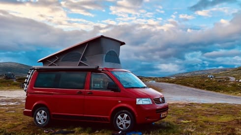 Red Volkswagen bus California T5