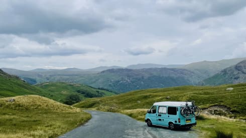 Retro turquoise camper, ready for a road trip. 