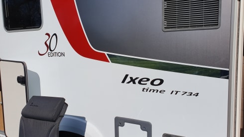 luxury camper including queen-size bed, pull-down bed and large garage and tow bar