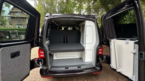 Biscy – 4 berth VW Campervan (Gas stove, 2 double beds, & gated car storage)