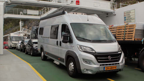 Bus camper with awning, private shower and toilet.