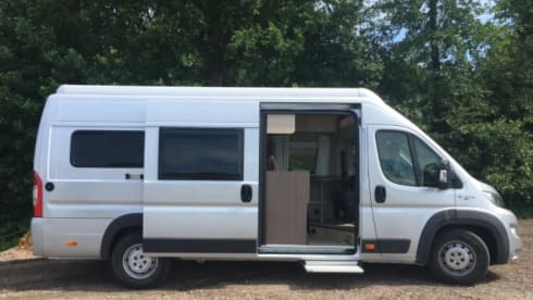 Bus camper with awning, private shower and toilet.
