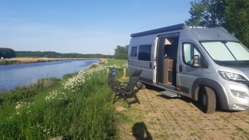 Bus camper with awning, private shower and toilet.