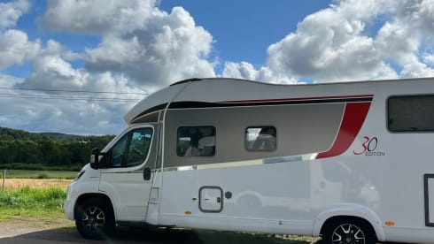 luxury camper including queen-size bed, pull-down bed and large garage and tow bar