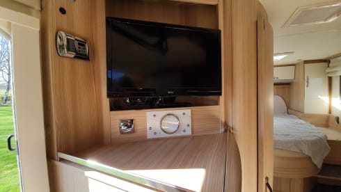 luxury camper including queen-size bed, pull-down bed and large garage and tow bar