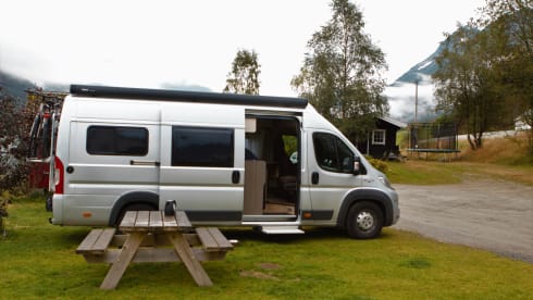 Bus camper with awning, private shower and toilet.