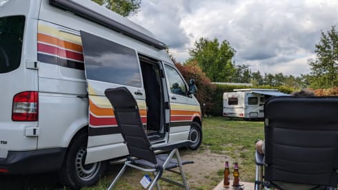 Retro Volkswagen Bus with bicycle carrier & awning