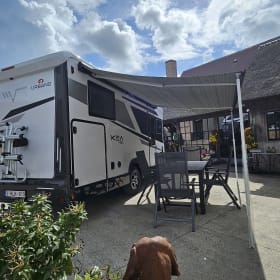 Luxury 4-person motorhome with bicycle rack and tow bar, model 2026