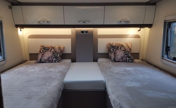 Luxury semi-integrated Burstner camper single beds & pull-down bed