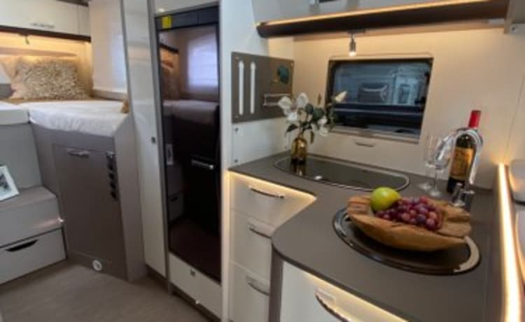 Luxury semi-integrated Burstner camper single beds & pull-down bed